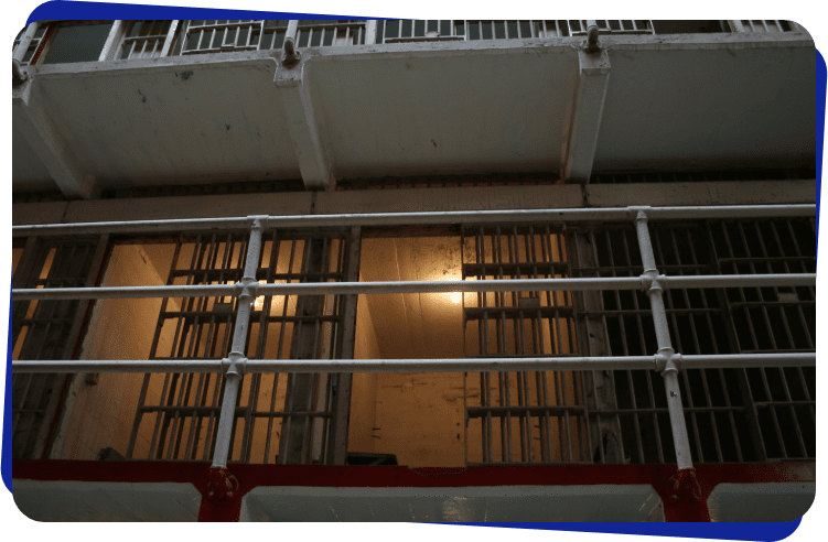 A picture of a prison cell with bars on it.